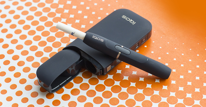 IQOS on orange dots background
